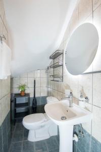 a bathroom with a sink and a toilet and a mirror at Gennadi Escape House in Gennadi +27 photos