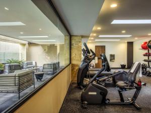 a gym with treadmills and elliptical machines at Novotel México City Centro Histórico in Mexico City