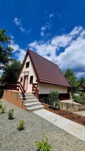a small house with a staircase in front of it at Ariel 2 Vendégház in Pilismarót