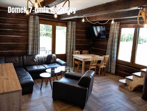a living room with a couch and a table at Górskie Marzenie - Apartament i Domek z sauną blisko Zatora i Energylandii in Przeciszów