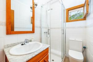 a bathroom with a sink and a shower at Can Jordi in Cala Llombards +28 photos