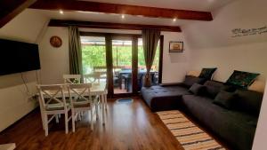 a living room with a couch and a table at Ariel 2 Vendégház in Pilismarót