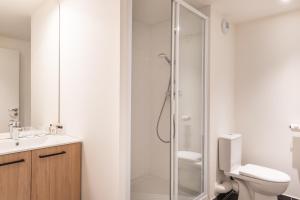 a bathroom with a shower and a toilet and a sink at Ibis Styles Paris Pont d'Ivry in Ivry-sur-Seine +14 photos