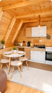 a kitchen with a table and chairs in a cabin at Holiday Home Veruša in Podgorica