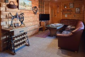 a living room with a couch and a table in a cabin at Chata Borovec in Veľké Borové