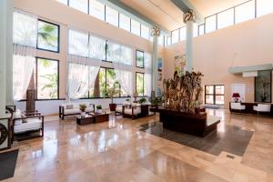 a large lobby with large windows and couches and tables at Leo Punta Umbría in Punta Umbría +30 photos