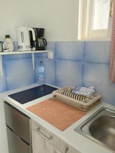 a kitchen with a sink and a counter top at Stelios Studios - Zante Seaview Nests in Tragaki