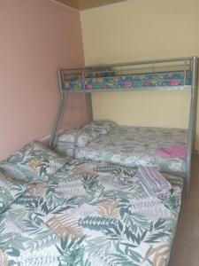 two bunk beds sitting next to each other in a room at Le camphrier in Salazie