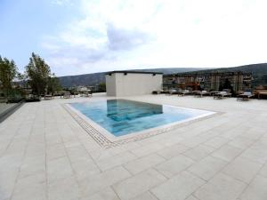 a swimming pool on the roof of a building at Novotel Tbilisi Center in Tbilisi City