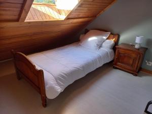 a bedroom with a bed with a wooden ceiling at Isa's Little Cottage in Saint-Bonnet-de-Chirac