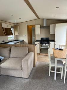 a living room and kitchen with a couch and a table at Drake 17 in Scarborough