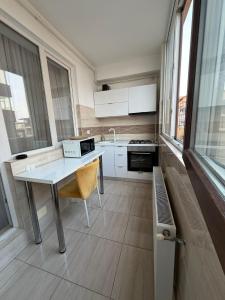 a kitchen with a table with a chair in it at RC RelaxApart 314 in Dudu