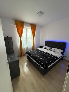 a bedroom with a large bed with a black headboard at RC RelaxApart 314 in Dudu