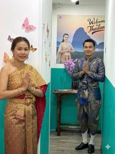 a man and a woman standing next to each other at Mamma Mia Rooms in Kata Beach