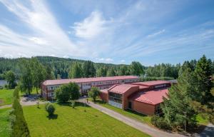 an overhead view of a large building with a field and trees at Old School in Suolahti