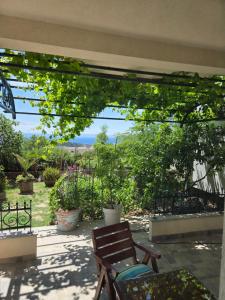 a patio with a bench and a view of a garden at Babić Rituals apartments in Makarska