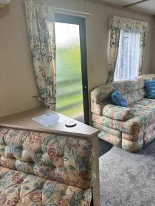 a living room with a couch and a couch and a table at 48 River View in Dunoon