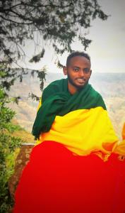 a man is holding a flag of nigeria at Abel haile in Moyalē