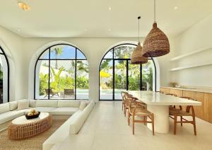 a living room with a white couch and a table at Dolce x The Young Villas in Uluwatu