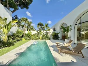 a swimming pool in the backyard of a house at Dolce x The Young Villas in Uluwatu