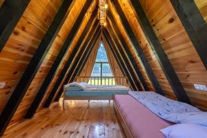 a bedroom in a tree house with a window at Ali-pašin Konak in Gusinje +53 photos