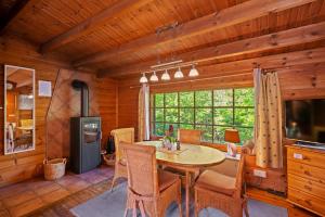a dining room with a table and chairs in a cabin at Ortheide 67 in Böddenstedt