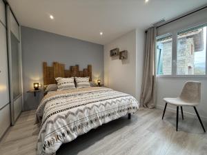 a bedroom with a bed and a chair and a window at Ibarnia in Suhescun +47 photos
