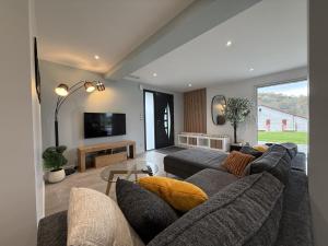 a living room with a couch and a tv at Ibarnia in Suhescun