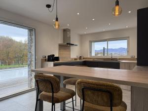 a kitchen with a large wooden table and chairs at Ibarnia in Suhescun