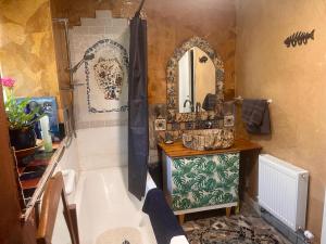 a bathroom with a tub and a sink and a mirror at Fabulous Glamping Yurt in Bantry +11 photos