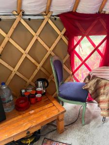a room with a table and a chair in a yurt at Fabulous Glamping Yurt in Bantry