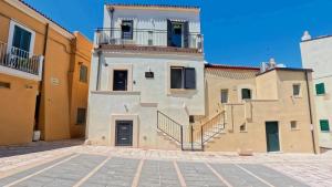 a building with stairs on the side of it at Tornola Luxury Rooms in Termoli