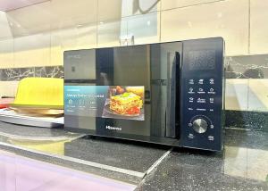 a microwave sitting on a counter in a store at Serene 5 Bedroom Duplex With Exclusive Compound in Iseri