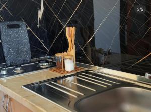 a kitchen counter top with a sink and a counter top with a counter sidx sidx at Mekli Guesthouse in (( Shën Ded Gjoni ))