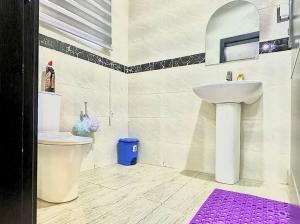 a bathroom with a sink and a toilet at Serene 5 Bedroom Duplex With Exclusive Compound in Iseri