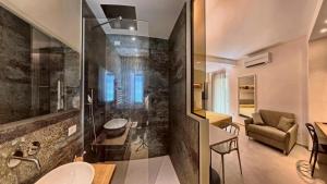 a bathroom with a sink and a glass wall at Tornola Luxury Rooms in Termoli +82 photos