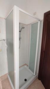 a shower with a glass door in a bathroom at La Perla di Sulmona in Sulmona +6 photos