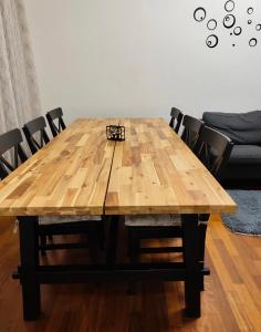 a wooden table with black chairs around it at La Perla di Sulmona in Sulmona