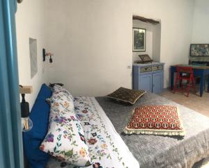 a bedroom with a bed with a pillow on it at Antica Verdureria in Terme di Castel Doria