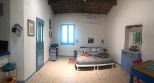 a bedroom with a bed and a desk and a window at Antica Verdureria in Terme di Castel Doria
