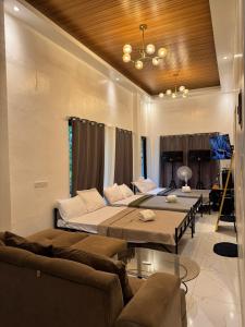 a living room with two beds and a couch at Urban Canopy City Forest Staycation in Tigbawan