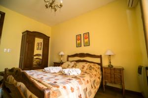 a bedroom with a bed with two pillows on it at Nuevos Horizontes in Tandil +21 photos