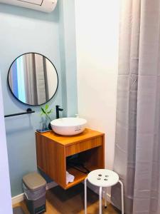a bathroom with a sink and a mirror at GASA Guesthouse in Compostela