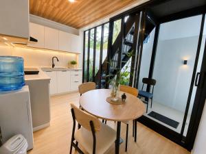 a kitchen and dining room with a table and chairs at GASA Guesthouse in Compostela
