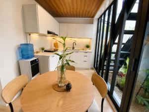 a wooden table with a vase on it in a kitchen at GASA Guesthouse in Compostela