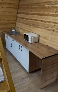 a kitchen counter with a microwave and a sink at Tau Saty in Saty