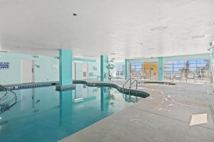 an empty building with a swimming pool in the middle at Bay Watch Resort 1735 - Direct Oceanfront Balcony with Pools and Lazy River in Myrtle Beach