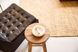 a candle sitting on a stool next to a couch at The Young Villas Tropical Villas in Seseh in Canggu