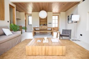 a living room with a couch and a table at The Young Villas Tropical Villas in Seseh in Canggu