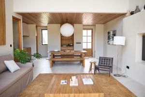 a living room with a couch and a table at The Young Villas Tropical Villas in Seseh in Canggu